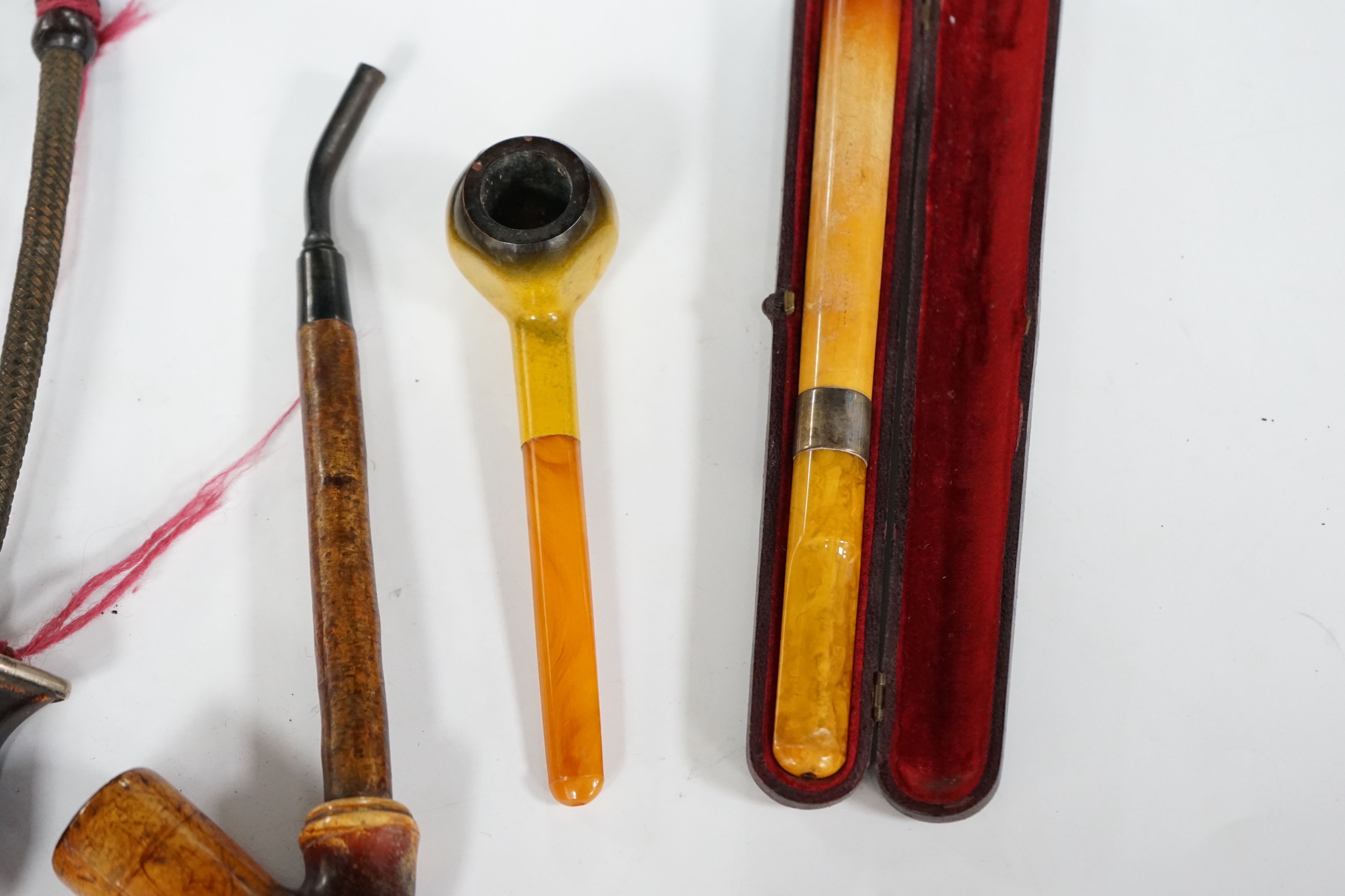 Seven pipes, three with amber mouthpieces, two cased and two without mouthpieces, longest cased pipe 20cm long